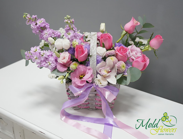 Basket with pink roses and stock photo